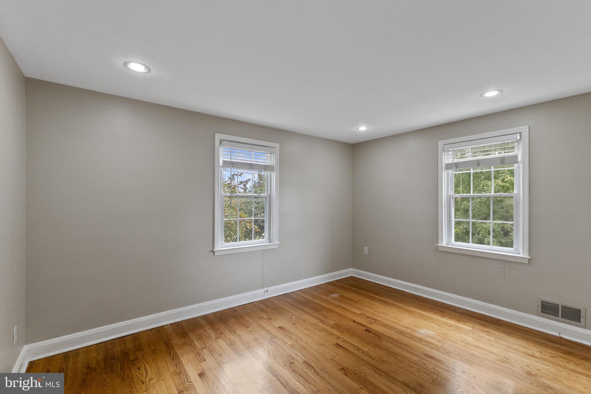 1541 Doxbury Road Baltimore, MD 21286 - Photo 27 of 37 an empty room with wooden floor and windows