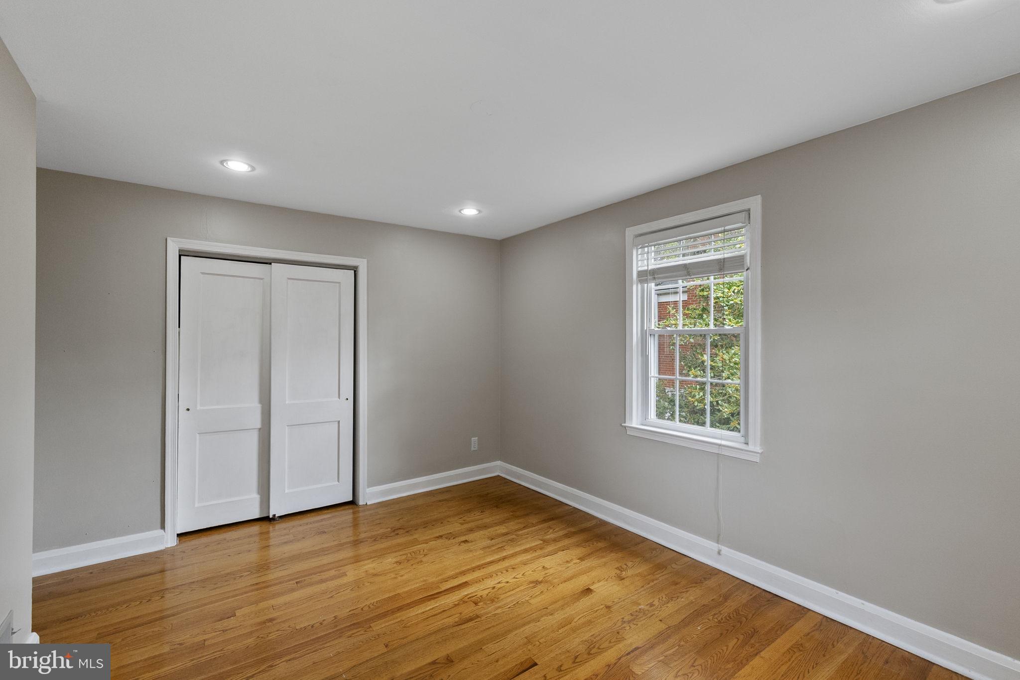 1541 Doxbury Road Baltimore, MD 21286 - Photo 28 of 37 an empty room with wooden floor and windows