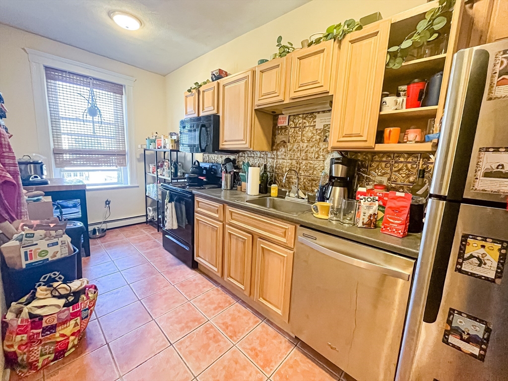 12 Ransom Road, Unit 6 Boston, MA 02135 - Photo 1 of 16 a kitchen with stainless steel appliances lots of counter top space