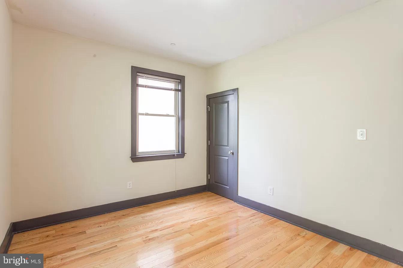 1826 West Norris Street, Unit 2 Philadelphia, PA 19121 - Photo 12 of 23 a view of an empty room with wooden floor and a window