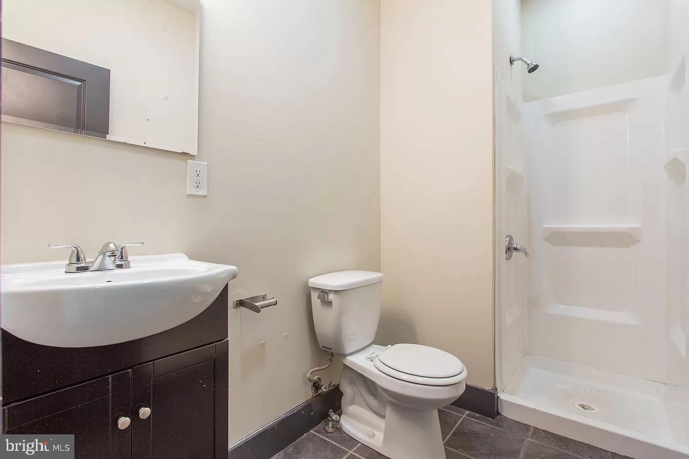 1826 West Norris Street, Unit 2 Philadelphia, PA 19121 - Photo 14 of 23 a bathroom with a sink a toilet and shower
