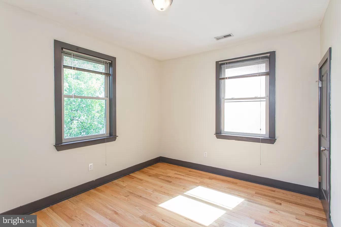 1826 West Norris Street, Unit 2 Philadelphia, PA 19121 - Photo 17 of 23 a view of an empty room with wooden floor and a window