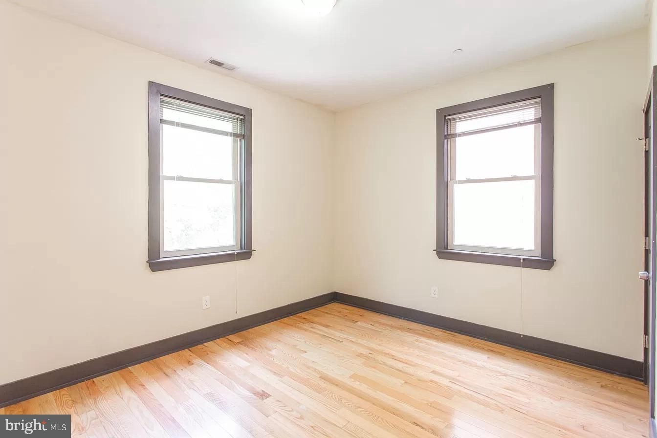 1826 West Norris Street, Unit 2 Philadelphia, PA 19121 - Photo 18 of 23 a view of an empty room with wooden floor and a window