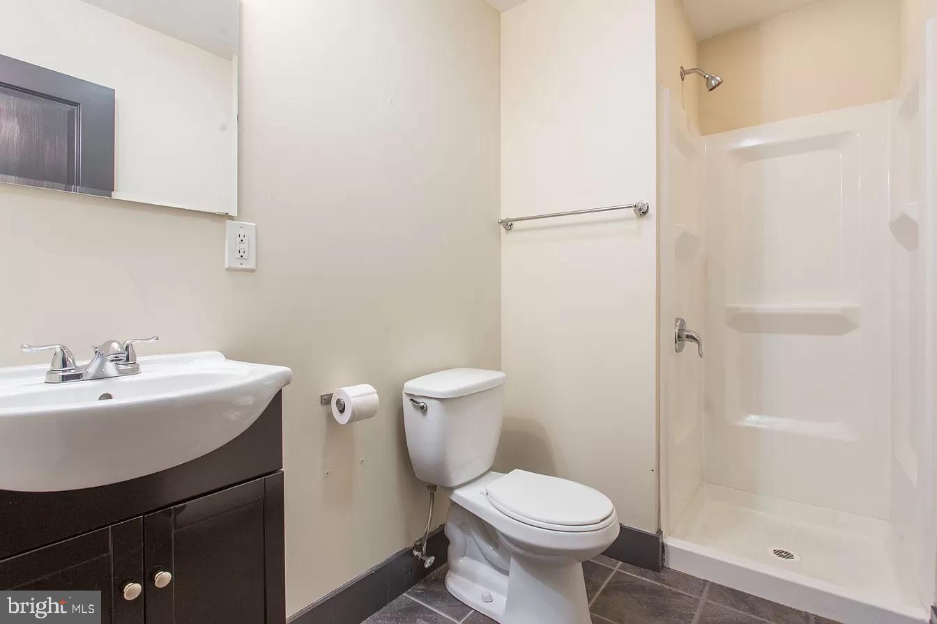 1826 West Norris Street, Unit 2 Philadelphia, PA 19121 - Photo 19 of 23 a white toilet sitting next to a bathroom sink