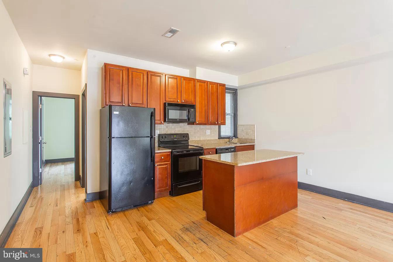 1826 West Norris Street, Unit 2 Philadelphia, PA 19121 - Photo 7 of 23 a kitchen with wooden cabinets and stainless steel appliances