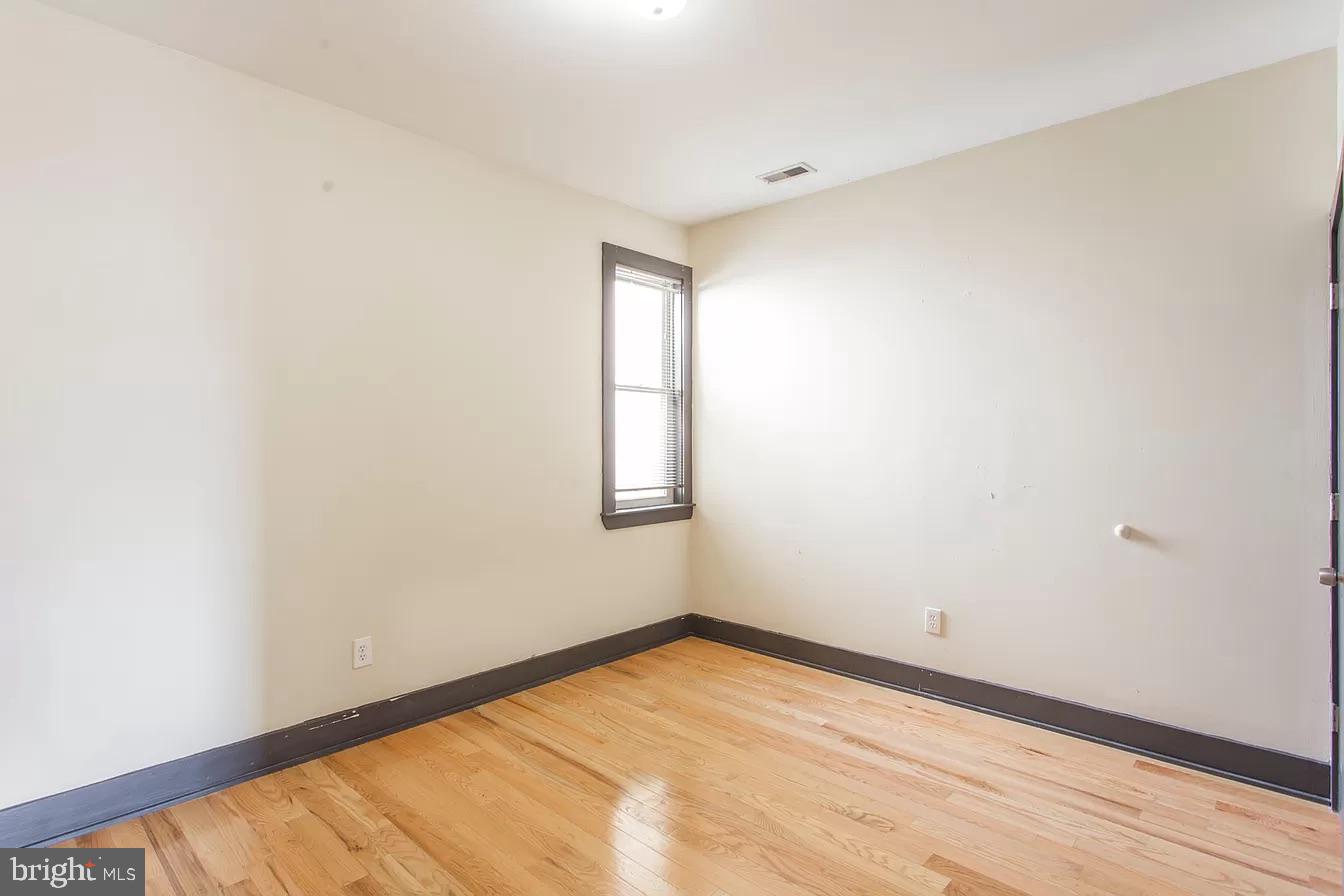 1826 West Norris Street, Unit 2 Philadelphia, PA 19121 - Photo 10 of 23 an empty room with wooden floor and windows