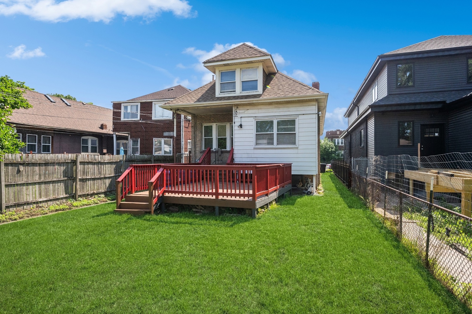 7348 South Indiana Avenue Chicago, IL 60619 - Photo 11 of 11 a view of a house with a yard and deck