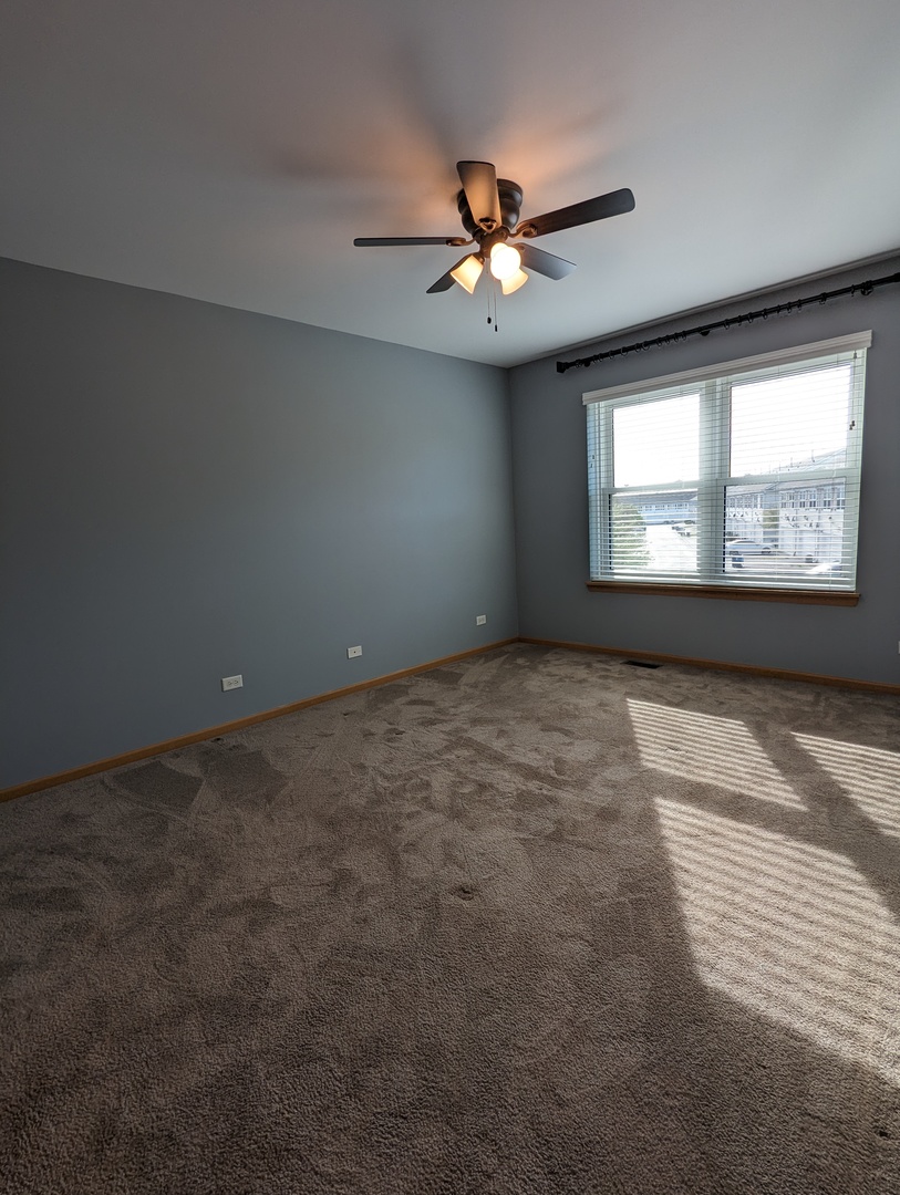 2257 Georgetown Circle Aurora, IL 60503 - Photo 10 of 19 a view of an empty room with a window