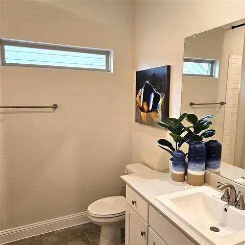 a bathroom with a sink a toilet and mirror