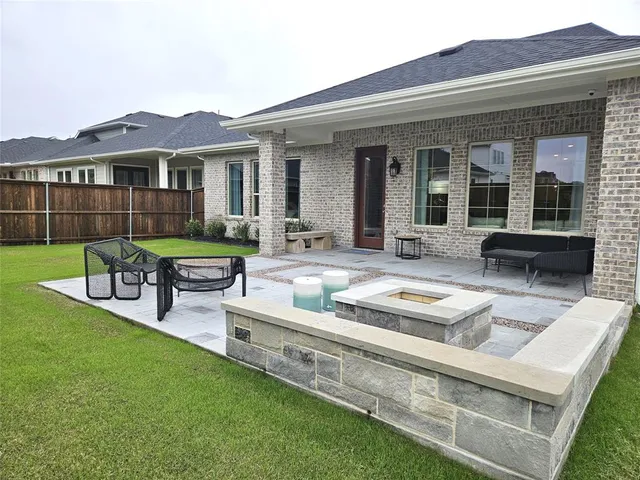 a view of a house with a backyard and sitting area