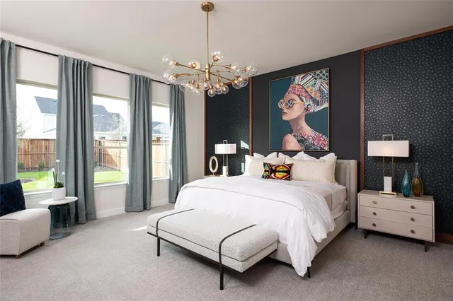 a bedroom with a large bed and a chandelier