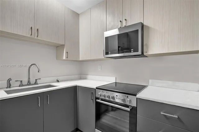a kitchen with a sink and cabinets