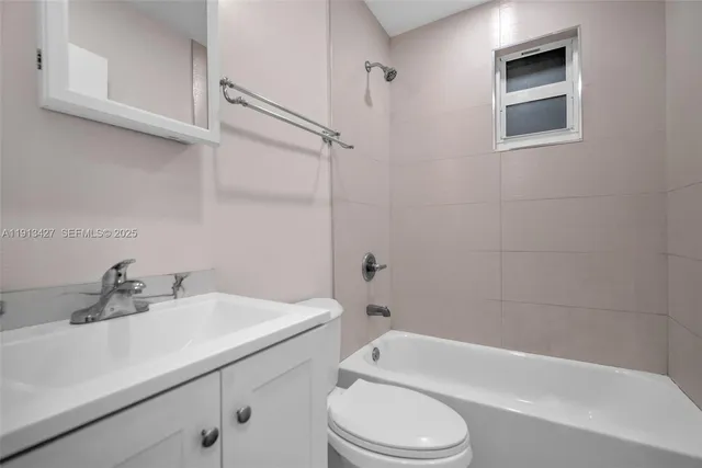 a bathroom with a sink a toilet and bathtub