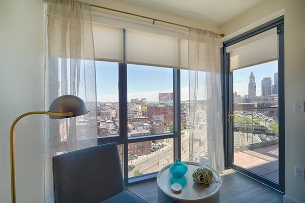 a living room filled with furniture and a floor to ceiling window