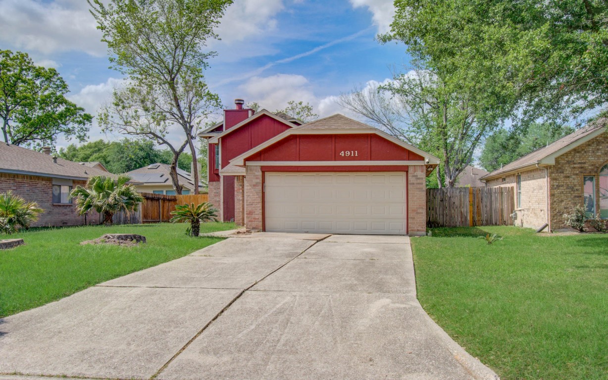 4911 Tealgate Drive Spring, TX 77373 - Photo 3 of 41 Charming single-story home with a red exterior and a two-car garage. It features a spacious driveway, neatly landscaped front yard, and mature trees. Perfect for families or first-time buyers seeking a cozy suburban setting.