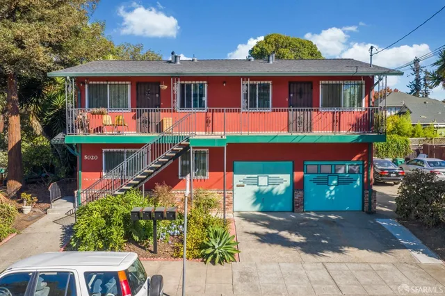a front view of a house with a yard garage and outdoor seating