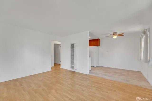 a view of empty room with ceiling fan
