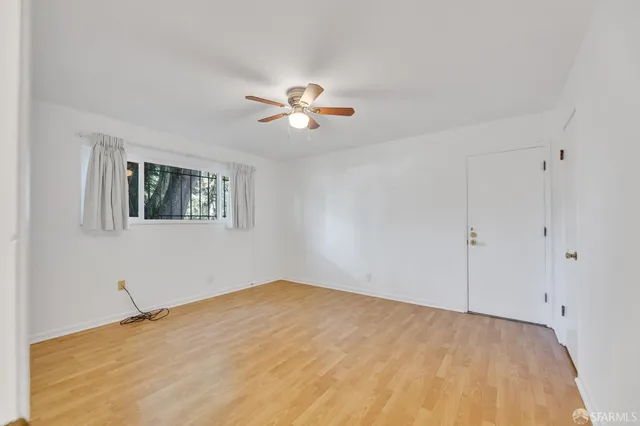 a view of a room with a ceiling fan and a window