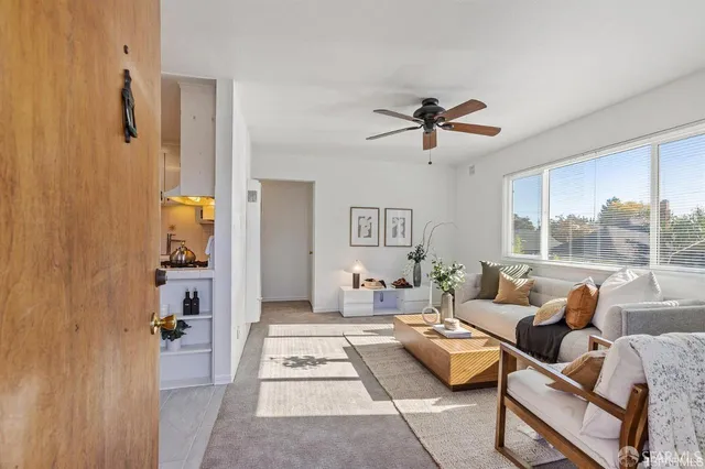 a living room with furniture and a chandelier