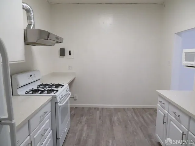 a kitchen with a stove and a refrigerator