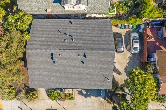 an aerial view of a house with a yard