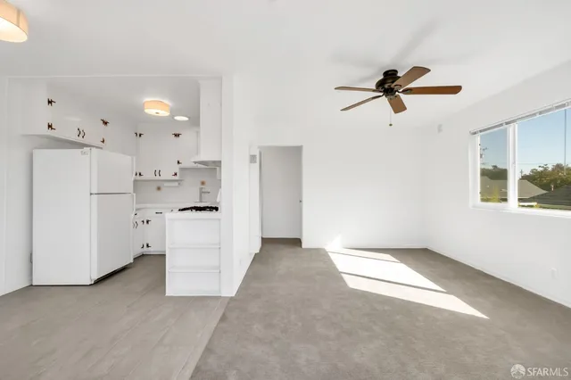 a view of a kitchen with a white cabinet and a stove top oven