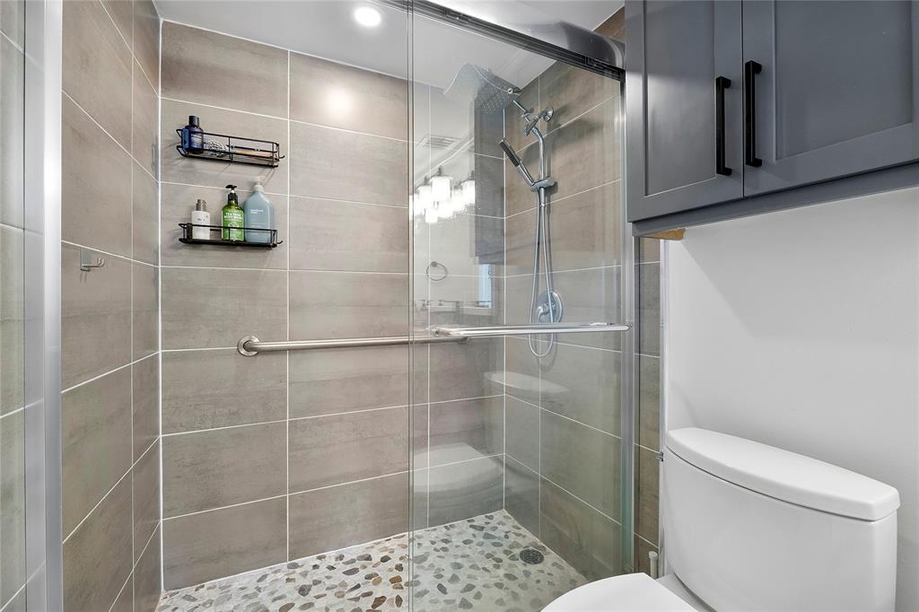 1505 North Riverside Drive, Unit 1003 Pompano Beach, FL 33062 - Photo 14 of 33 a bathroom with a toilet and shower