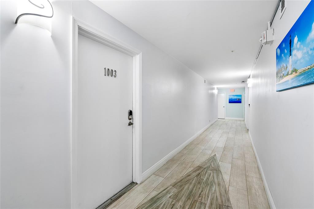 1505 North Riverside Drive, Unit 1003 Pompano Beach, FL 33062 - Photo 15 of 33 a view of a hallway with wooden floor