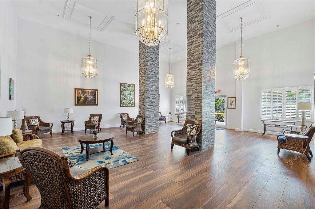 1505 North Riverside Drive, Unit 1003 Pompano Beach, FL 33062 - Photo 16 of 33 a living room with furniture chandelier and wooden floor
