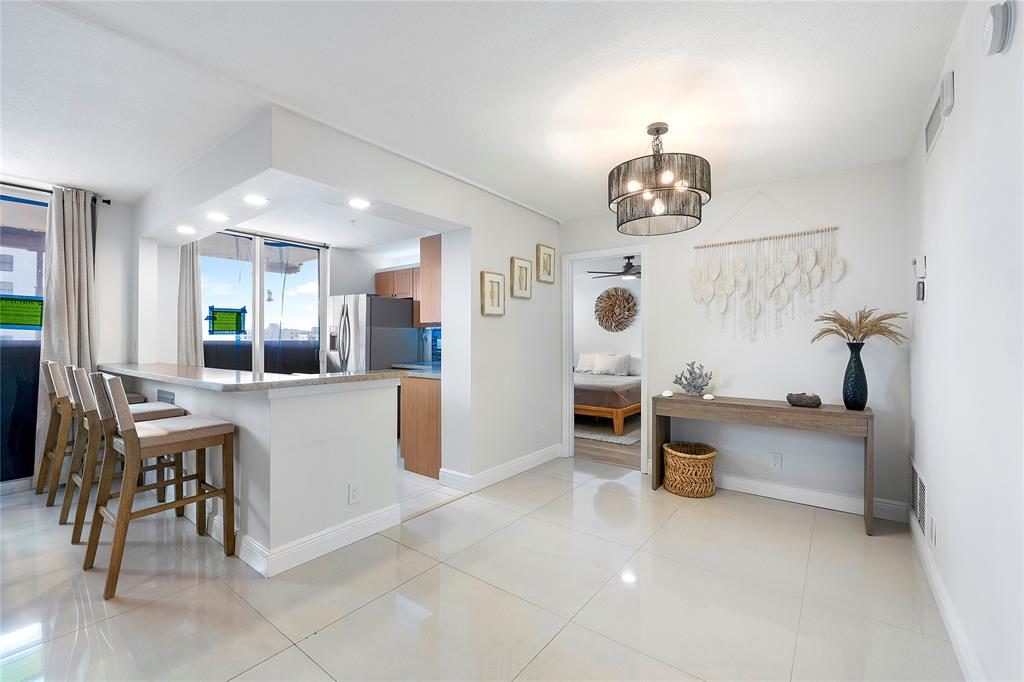 1505 North Riverside Drive, Unit 1003 Pompano Beach, FL 33062 - Photo 2 of 33 a view of kitchen with furniture and chandelier