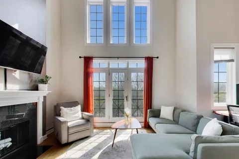 a living room with furniture a flat screen tv and a fireplace