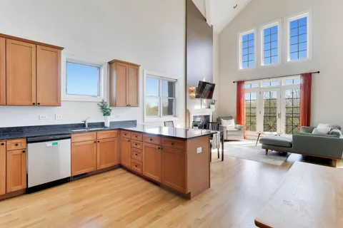 a large kitchen with stainless steel appliances granite countertop a couch and a counter space