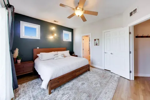 a bedroom with a bed and a chandelier