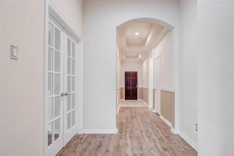 an empty room with wooden floor and closet