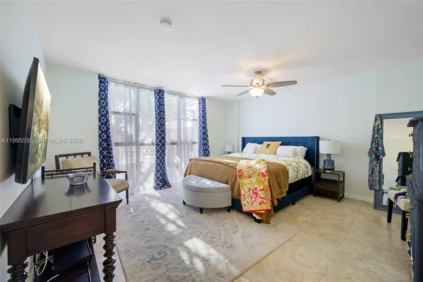 a bedroom with a bed a desk and chair