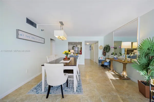 a dining room with furniture and window