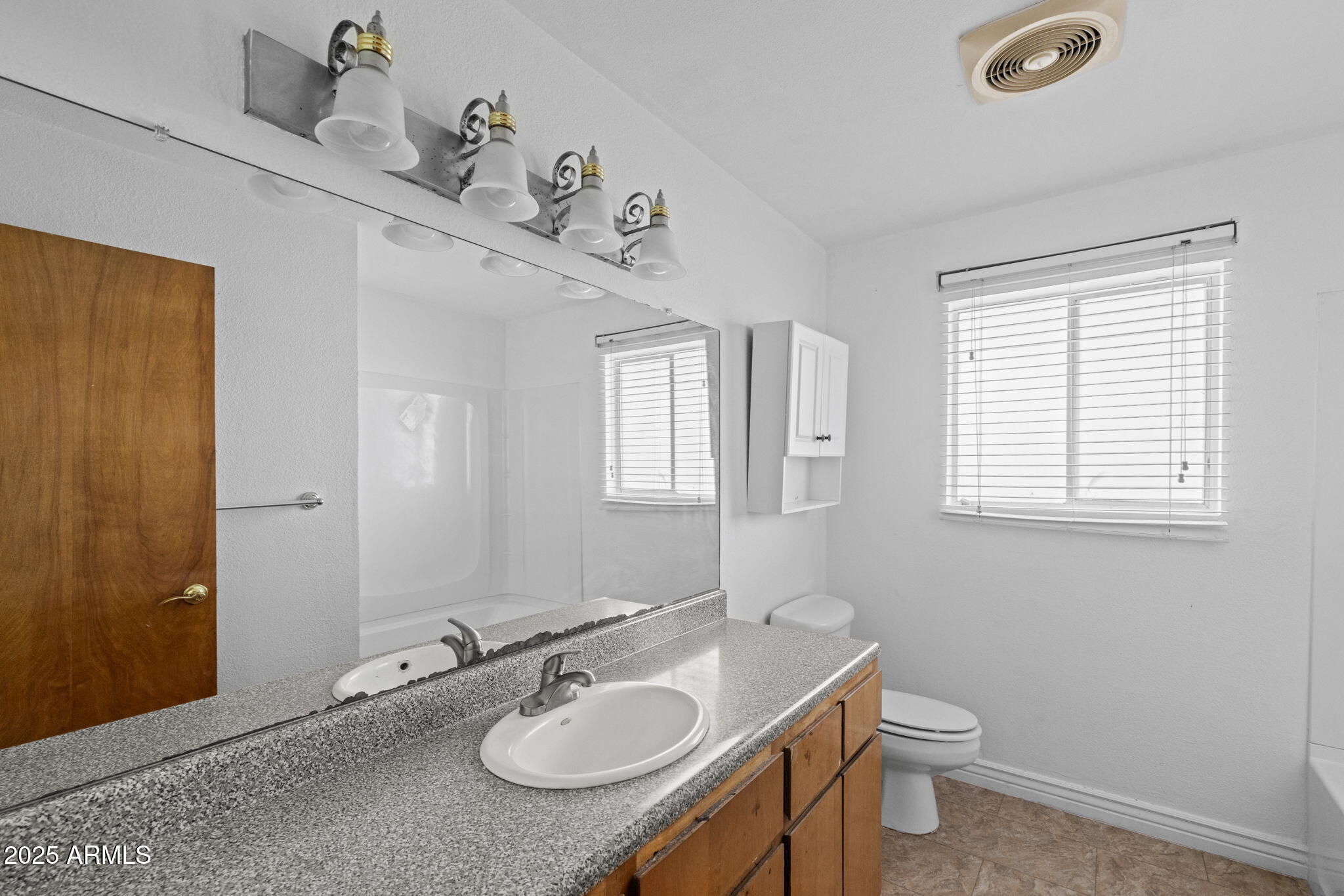 333 South Cooper Road Chandler, AZ 85225 - Photo 26 of 68 a bathroom with a granite countertop sink toilet and mirror