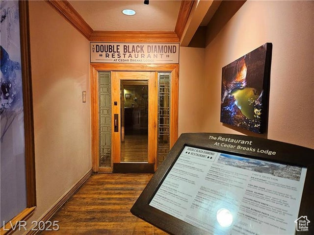 223 Hunter Ridge Drive, Unit E121 Brian Head, UT 84719 - Photo 25 of 35 Hallway featuring ornamental molding and dark wood-style floors