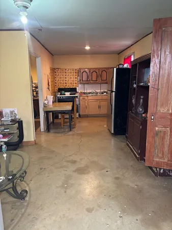 a kitchen with refrigerator and cabinets