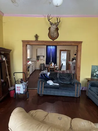 a living room with furniture and a wooden floor