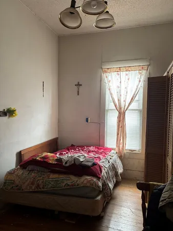 a bedroom with a bed and a window
