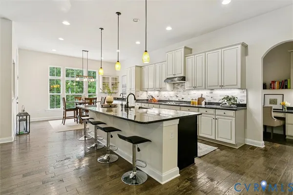 a view of a hallway with wooden floor and stairs