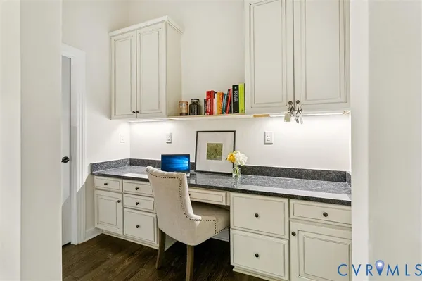 a kitchen with stainless steel appliances kitchen island granite countertop a refrigerator a stove a sink dishwasher and a dining table with wooden floor