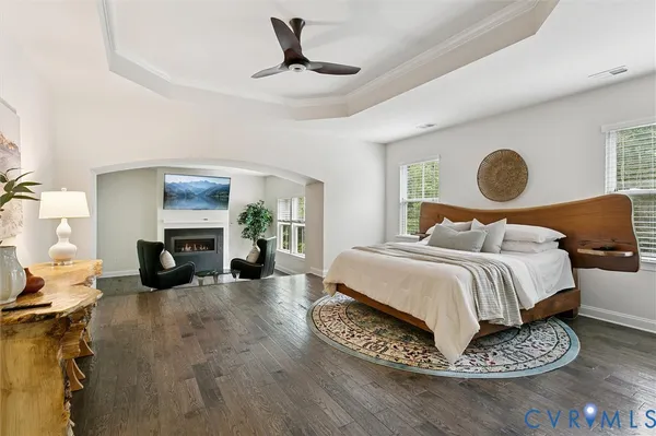 a kitchen with stainless steel appliances granite countertop a stove a refrigerator a sink a dining table and chairs with wooden floor