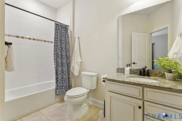 a room with gym equipment and wooden floor