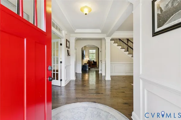 a view of a livingroom with furniture wooden floor and windows