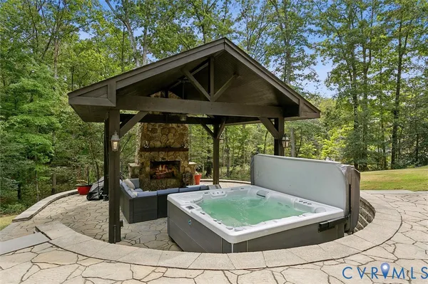 an aerial view of a house with a yard and outdoor seating