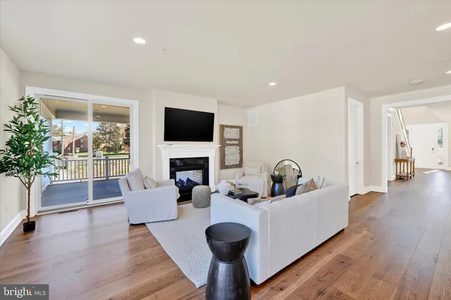a kitchen with stainless steel appliances kitchen island granite countertop a table chairs and a refrigerator