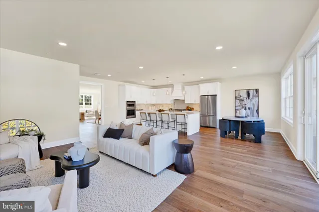 a kitchen with a white dining table and chairs