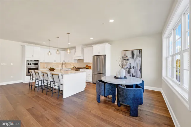 a view of a dining room with furniture window and wooden floor